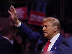 Republican presidential nominee former President Donald Trump waves at a campaig...