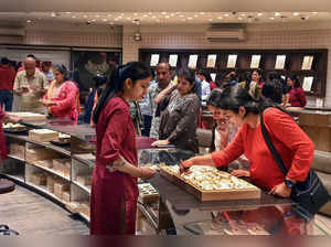 Ahmedabad, Oct 24 (ANI): Women shop gold and silver jewelry on the occasion of '...