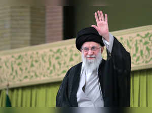 Iran's Supreme Leader Ayatollah Ali Khamenei waves during a meeting with students in Tehran