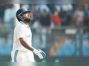 Mumbai: India's captain Rohit Sharma walks off the field after losing his wicket...