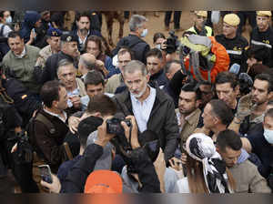 A crowd of Spain's flood survivors toss mud and shout insults at King Felipe VI