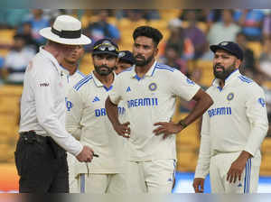 Bengaluru: India’s captain Rohit Sharma and other players interact with umpires ...