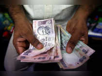 Indian Rupee closes at record low of 84.11 vs US dollar on foreign selloff