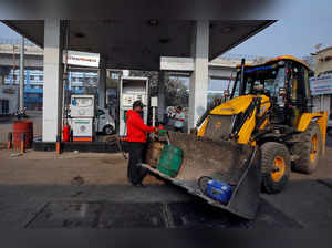 FILE PHOTO: A worker fills diesel in a container at a fuel station in Kolkata