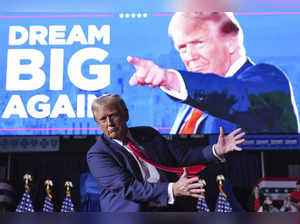 Republican presidential nominee former President Donald Trump gestures at a camp...