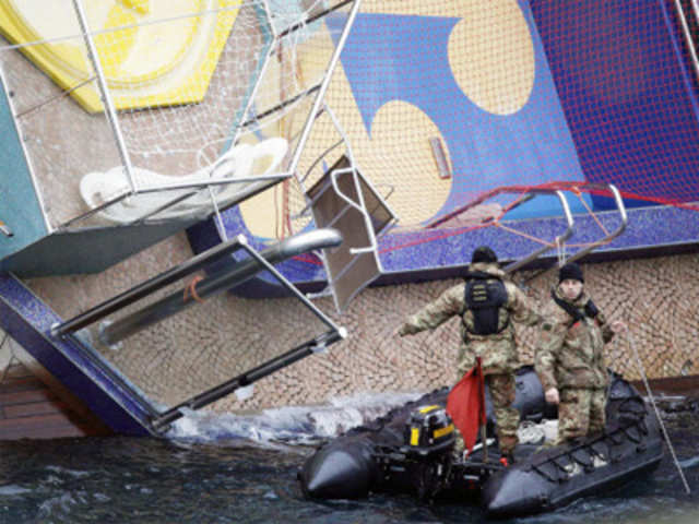 Rescue workers patrol next to Costa Condordia