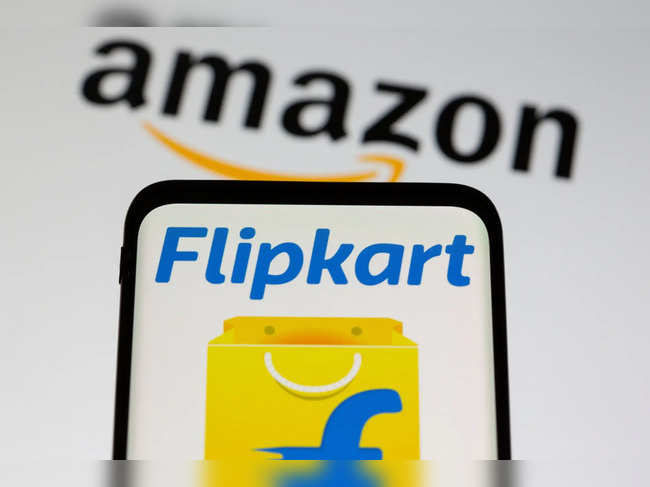 Smartphone with Flipkart logo is seen in front of displayed Amazon logo in this illustration