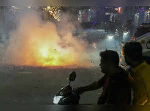 New Delhi: People burst firecrackers during the Diwali festival celebrations, in...