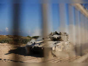 An Israeli tank manoeuvres before entering into the Gaza Strip at the Kerem Shalom crossing