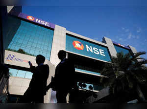 FILE PHOTO: People walk outside the National Stock Exchange (NSE) in Mumbai