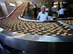 FILE PHOTO: A worker stands next to a production line at the Britannia biscuit factory in New Delhi