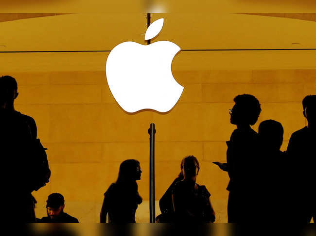 Customers walk past an Apple logo inside of an Apple store at Grand Central Station in New York