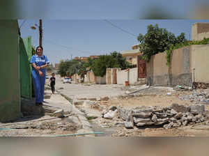 Rafida Naif Yazidi, a member of Iraq's Yazidi minority who was captured and enslaved by the Islamic State group, poses for the camera in Sinjar,