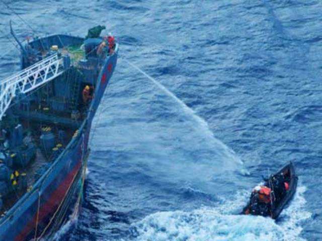 Japenese whaling vessel sprays water on conservationists