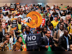 Activists protest to urge world leaders to commit to a strong climate finance deal during COP29, in Baku