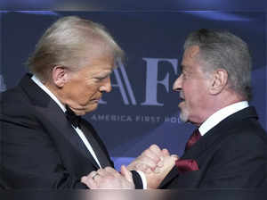 President-elect Donald Trump greets actor Sylvester Stallone during an America F...