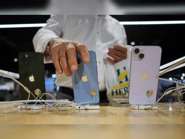 A man looks at Apple iPhones at a shop in Bilbao