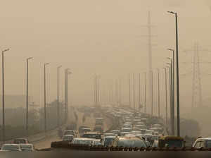 FILE PHOTO: Vehicles drive on a highway on a polluted smoggy morning in New Delhi