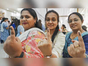 Thane: Government employees on election duty pose after casting their votes thro...