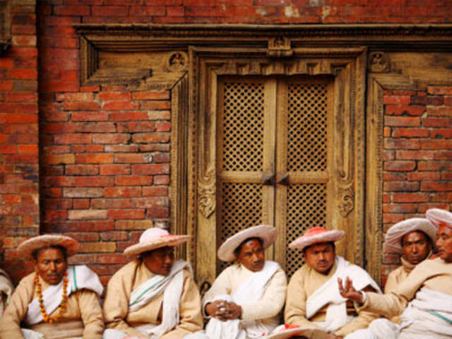 Priests take a break during the Shikali festival in Lalitpur