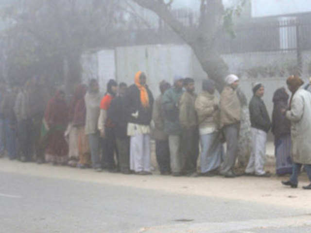 People queue to collect free tea and biscuits