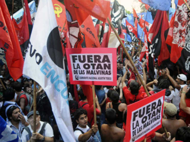 Argentine activists hold a posters