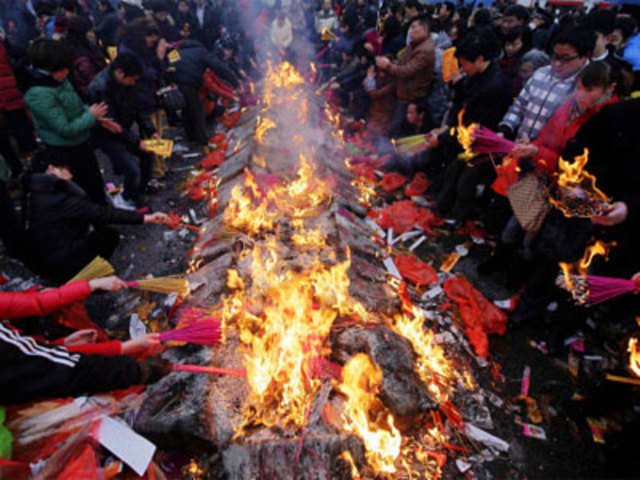 People burn incense sticks during Lunar New Year celebrations