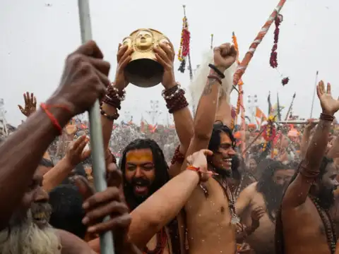 Naga Sadhus take a holy dip during the Maha Kumbh Mela