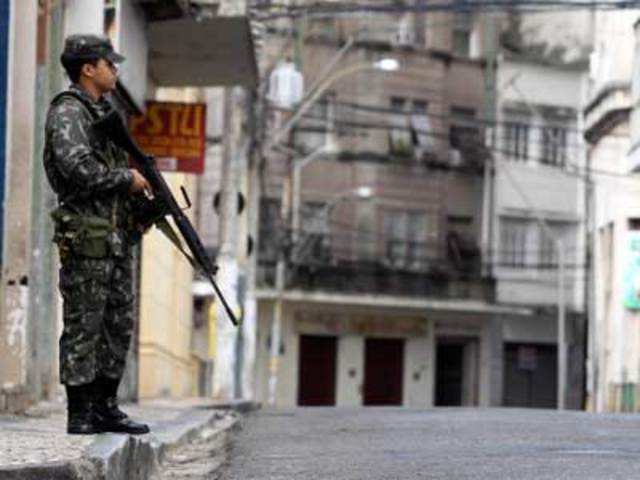 A Brazilian soldier guards a street