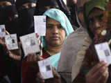 Voters display their voter identity cards