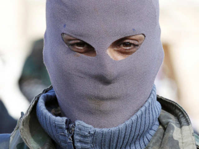 A masked Syrian rebel