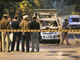 A worker sweeps debris at the blast site