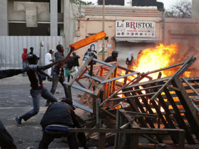 Anti-govt protesters erect a burning street barricade in central Dakar, Senegal 