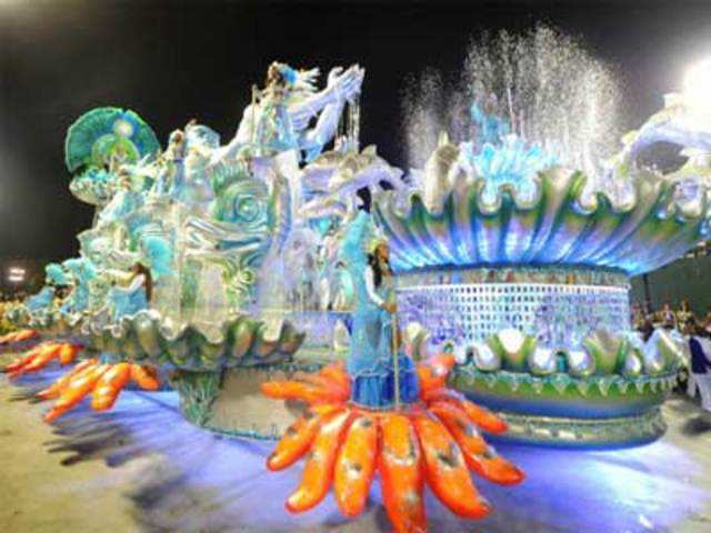 A reveller performs during carnival parade