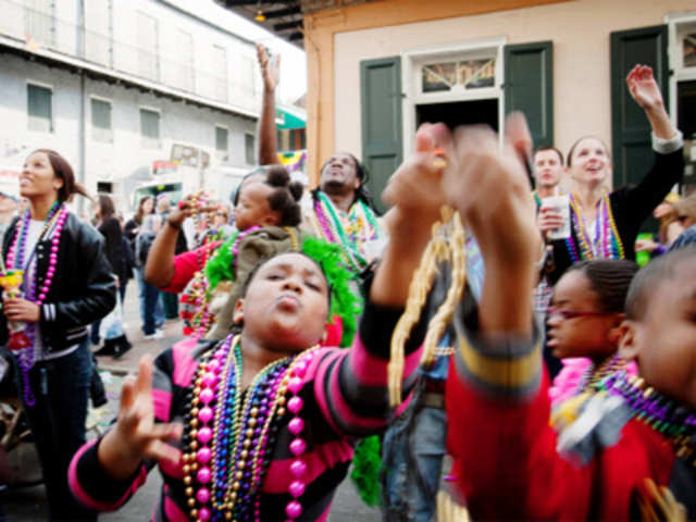 Kamaya Walters grabs beads during Mardi Gras celebrations