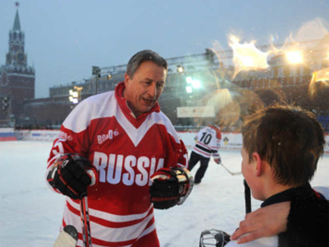 Soviet hockey star Alexander Yakushev talks to a young hockey player at the Red square