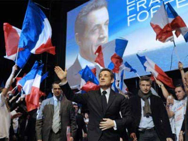 Nicolas Sarkozy arrives on stage during a campaign meet