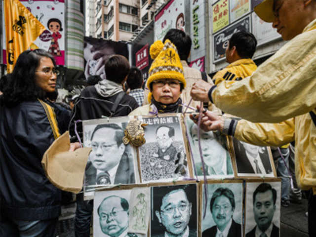 Protesters stage a demonstration against Donald Tsang