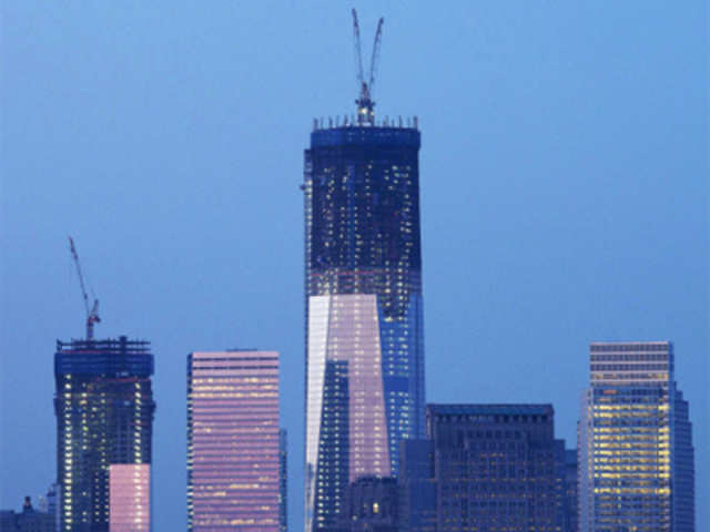Cranes work on top of One World Trade Center