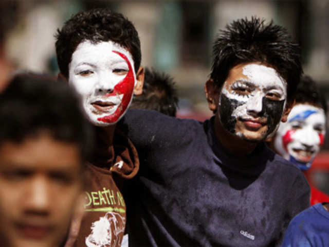 Nepalese boys with their faces smeared with color