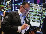 Nasdaq, S&P 500 close lower, weighed by tech stocks, Dow ends up
