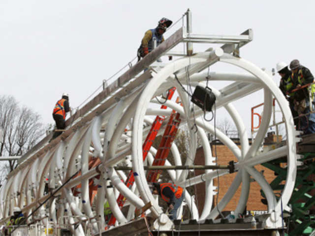 Workers prepare an elevated walkway