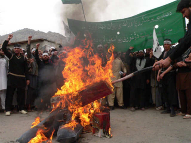 Afghan demonstrators burn an effigy of Barack Obama