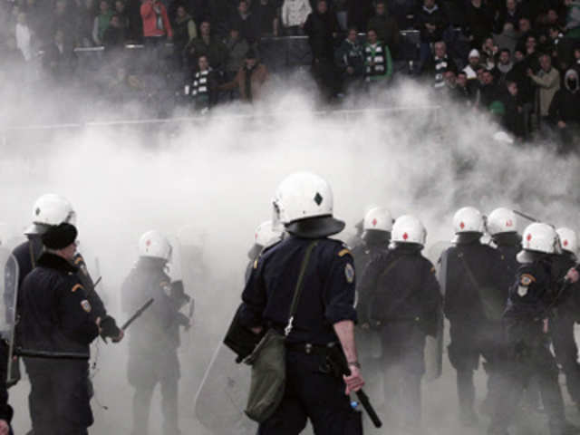 Riot police confronting fans during Greek Super League soccer game