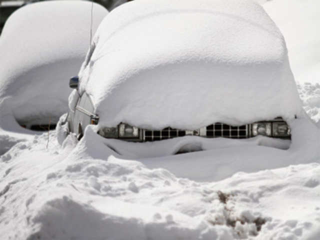 Snow blankets two cars after a winter storm in Flagstaff
