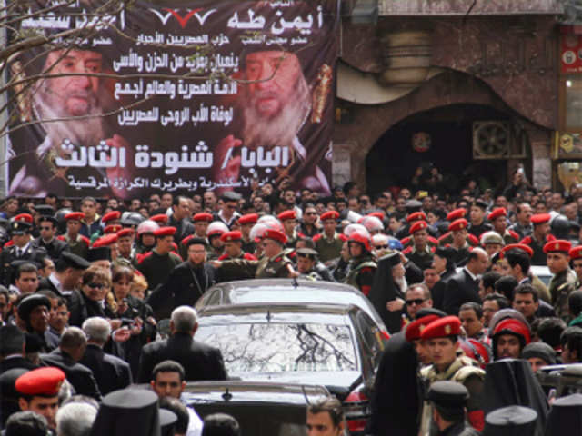 A hearse carries away Pope Shenouda III's casket after his funeral mass at the Coptic Orthodox cathedral in Cairo