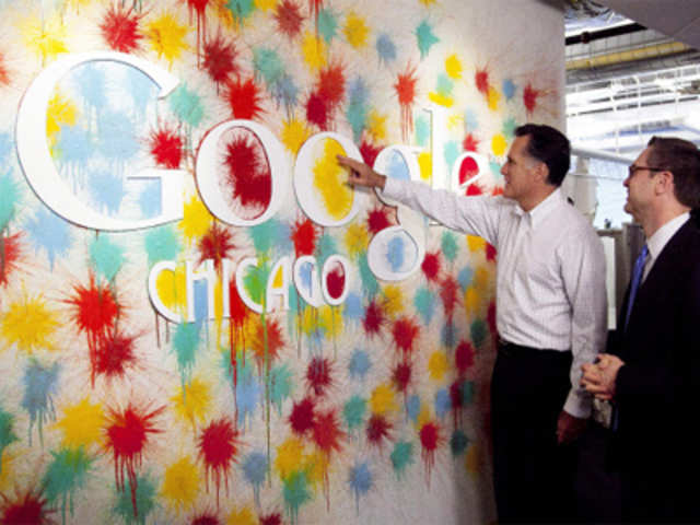 Mitt Romney examines a Google logo