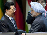 China's President shakes hands with Manmohan Singh