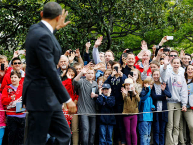 Barack Obama waves to visitors at White House