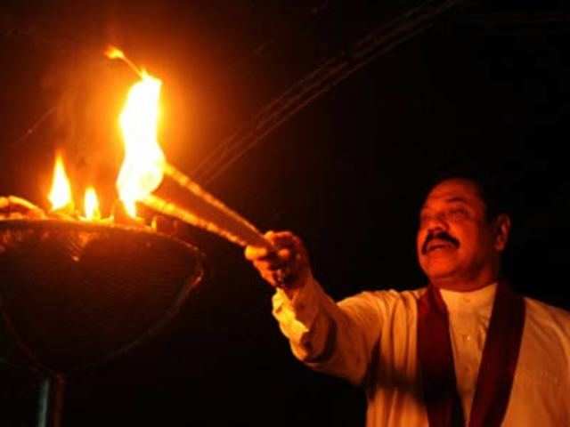 Sri Lankan President Mahinda Rajapakse lights a candle
